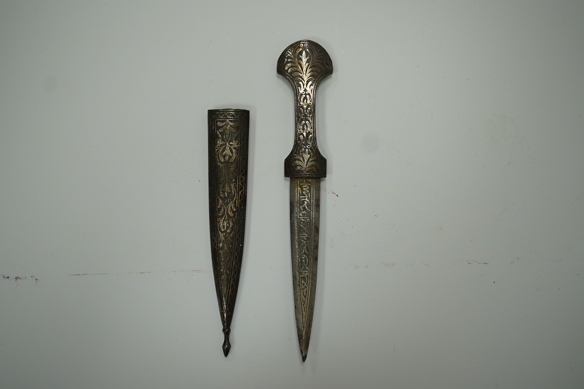 An Ottoman silver damascened dagger c.1900 in matching sheath, blade 9.7cm. Condition - fair